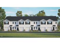 Front view of townhouses with garages and landscaping at 446 Belgian Red Way, Wake Forest, NC 27587