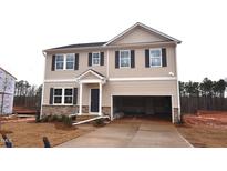 Charming two-story home with stone accents, an attached garage, and a well-manicured lawn at 45 Calabria Ct, Franklinton, NC 27525