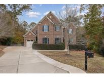 Brick two-story house with driveway and landscaping at 5040 Darcy Woods Ln, Fuquay Varina, NC 27526