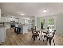 Spacious kitchen featuring modern appliances and an island at 8225 Fieldcrest Ln, Fuquay Varina, NC 27526