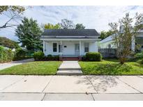 Charming white house with brick steps, a well-maintained lawn, and sidewalk at 127 E Ridge St, Rocky Mount, NC 27804