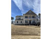 Elegant two-story home with a covered front porch and meticulous yard at 427 Rising Star Dr, Clayton, NC 27520