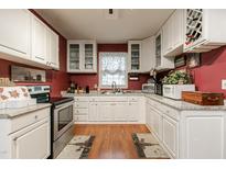 Bright kitchen features white cabinets, stainless steel appliances, and granite countertops at 6238 Old 421 Rd, Liberty, NC 27298