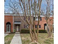 Brick townhouse exterior with landscaping and walkway at 6409 New Market Way, Raleigh, NC 27615
