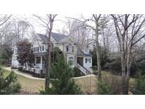 Two-story house with stone accents and a wrap-around porch at 7400 Duncans Ridge Way, Fuquay Varina, NC 27526