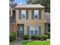 Tan two-story home with gray shutters and well-maintained lawn at 11 Stone Village, Durham, NC 27704