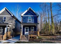 New construction home with navy blue siding and wooden porch at 1129 Elmo St, Durham, NC 27701