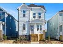 Two-story light blue house with white trim and wooden steps at 1569 Piney Fls Dr, Wendell, NC 27591