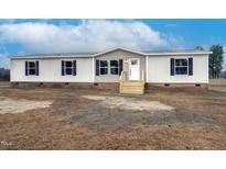 Single-wide manufactured home with brick skirting and wooden steps at 2000 Exum Rd, Nashville, NC 27856