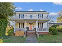 Two-story home with wraparound porch and balcony at 204 E Mason St, Franklinton, NC 27525