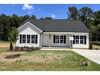Charming single-story home with white siding, black shutters, and a well-manicured lawn at 286 Longbow Dr, Middlesex, NC 27557