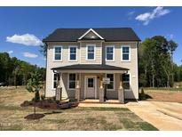 Two-story home boasts a charming front porch and a classic design in a picturesque setting at 302 Longbow Dr, Middlesex, NC 27557