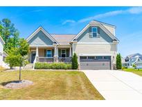 Beautiful two-story home with a large front porch and attached garage at 853 Airedale Trl, Garner, NC 27529