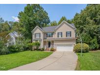 Charming two-story home featuring a well-maintained yard, two car garage, and lush landscaping at 106 Dairy Ct, Chapel Hill, NC 27516