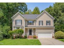 Two-story house with beige siding, black shutters, and a two-car garage at 106 Dairy Ct, Chapel Hill, NC 27516