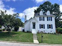 Charming two-story white home with blue shutters and well-maintained front yard at 110 Ethans Glenn Ct, Cary, NC 27513