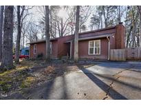 Charming, well-maintained home with a classic brick chimney and lovely front yard at 1225 Kilmory Dr, Cary, NC 27511