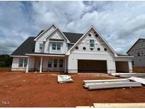 New two-story home features a white exterior, dark roof, and an attached two-car garage at 132 Tennyson Dr, Garner, NC 27529