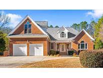 Brick home with two-car garage and landscaped yard at 1801 Amethyst Ridge Dr, Raleigh, NC 27604