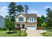 Charming two-story home with a well-manicured lawn and inviting curb appeal at 4538 Brighton Ridge Dr, Apex, NC 27539