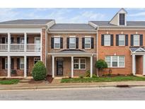 Brick townhouse with front porch and landscaping at 1328 Regulator St, Raleigh, NC 27603