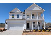 Charming two-story home featuring a welcoming front porch and attached two-car garage at 143 Steppe Way, Garner, NC 27529
