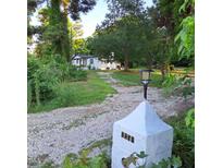 Quaint ranch home with a gravel driveway and a well-manicured lawn at 3259 Us 421, Lillington, NC 27546