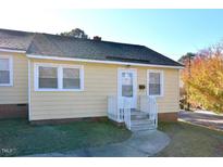 Cute yellow house with white trim and steps leading to the front door at 331 Clark St, Durham, NC 27701