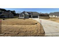 Newly constructed home with gray siding and a two-car garage at 105 Hydrangea Ln, Benson, NC 27504