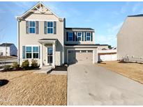 Two-story house with beige siding, gray shutters, and a two-car garage at 1140 Bridgewater Dr, Durham, NC 27704