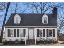 Charming one-story house with white siding, dark shutters, and a brick chimney at 1809 Burnt Mill Rd, Rocky Mount, NC 27804