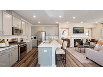 Open concept kitchen features stainless steel appliances and an island at 1878 Sweet Gardenia Way, Apex, NC 27502