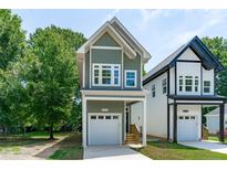 Two story new construction home with gray and white siding and two car garage at 2210 Edwin Ave # B, Durham, NC 27705