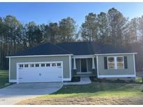 Newly constructed home with a two-car garage and landscaped yard at 309 Magnolia Run Way, Benson, NC 27504