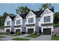 Four modern townhouses with attached garages and landscaping at 4075 Elk Creek Ln # 9, Raleigh, NC 27612