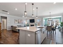 Modern kitchen with large island, stainless steel appliances, and white cabinetry at 88 Capewood Ct, Garner, NC 27529