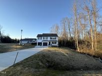 Two-story home with dark gray accents and a two-car garage at 228 Mahogany Way, Four Oaks, NC 27524