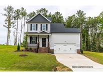 Two-story house with gray siding, dark roof, and attached garage at 243 Danube Dr, Zebulon, NC 27597