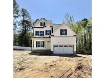 Charming new construction home featuring a two-car garage, black shutters, and a spacious front yard at 2628 Silver Gate Ct, Wake Forest, NC 27587
