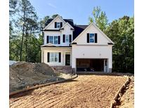 New construction home with white siding, black shutters, and an unfinished driveway at 2628 Silver Gate Ct, Wake Forest, NC 27587