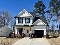 Charming new construction with white siding, black shutters, and a one-car garage at 420 Maidenhair Pl, Clayton, NC 27520