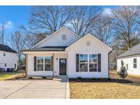Charming white house with black accents and a spacious front yard at 617 Ray St, Selma, NC 27576