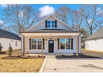 Charming craftsman style home with gray siding, black shutters, and a covered porch at 619 Ray St, Selma, NC 27576