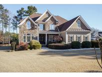 Stunning two-story home with stone accents and a landscaped lawn at 8305 Rue Cassini Ct, Raleigh, NC 27615