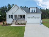 Charming home featuring a stone foundation, gray siding, black shutters, and a two-car garage at 95 Purslane Dr, Franklinton, NC 27525