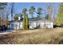 White single story home with mature trees and landscaping at 101 Oakmont Ave, Durham, NC 27713