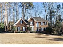 Brick two-story house with a large front yard and mature trees at 108 Heart Pine Dr, Cary, NC 27518