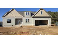 New construction home with two-car garage and attractive exterior at 129 Lassiter Ridge Dr, Four Oaks, NC 27524