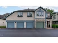Three-car garage, stone accents, and a charming front entrance at 201 Presque Isle Ln, Chapel Hill, NC 27514