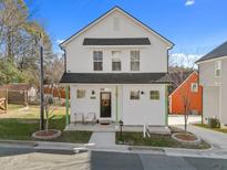 Two-story white house with dark gray roof and green accents at 2804 Cannada Ave, Durham, NC 27704